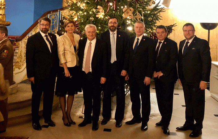 Ambassador Baiba Braze of Latvia and fellow NATO colleagues admire the Latvian Christmas Tree at Lancaster House with its designer NATO stars