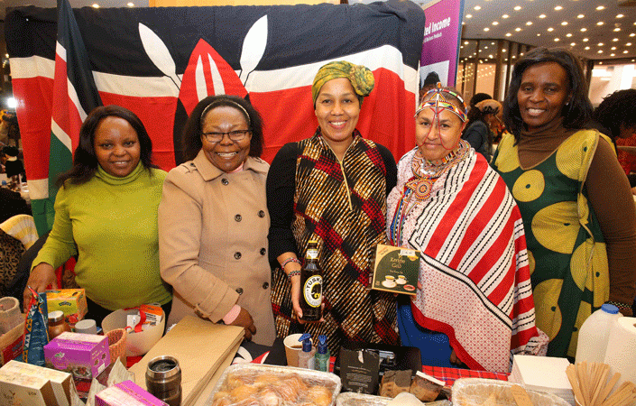 The wife of Kenya’s High Commissioner, Lynne Janis Waithiegeni Kanguru-Esipisu, joins the team at the country’s stall